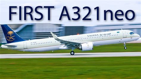 Airbus A321neo Saudia colors parked at terminal with passengers boarding jet bridge