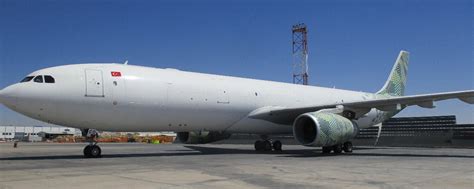 Airbus A330-300P2F cargo freighter alongside Boeing 767 freighter at an air cargo airport