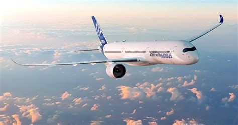 airbus a350 in flight over green landscape with blue sky