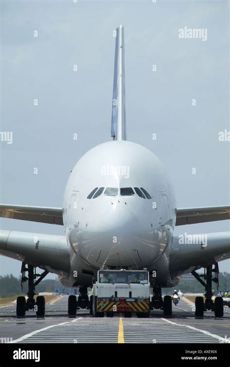 Airbus A380 being towed through narrow terminal taxiway