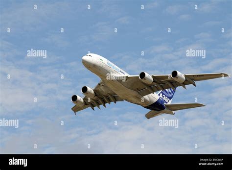 Airbus A380 double deck aircraft in flight above clouds with four engines visible