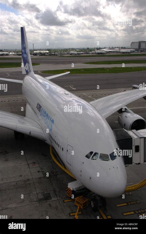 Airbus A380 parked at Heathrow Terminal 5 surrounded by widebody aircraft