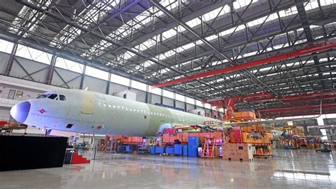 Airbus-China assembly line staff working on narrowbody aircraft at Tianjin facility