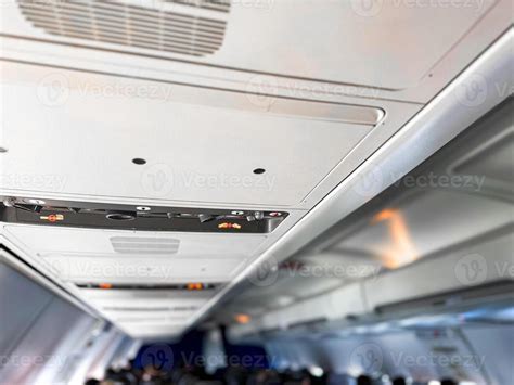 aircraft cabin interior showing overhead air vents and passenger seating