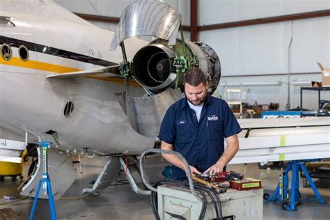 aircraft fuselage opened during D check with technicians performing full structural inspection