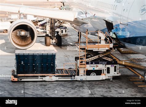 Aircraft loading freight at Suvarnabhumi Airport cargo terminal at night