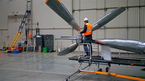 aircraft maintenance technician inspecting constant speed propeller hub for oil leaks and blade condition