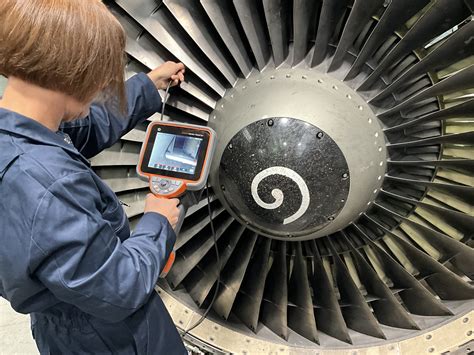 aircraft mechanic using borescope to inspect internal baffles of fuel tank