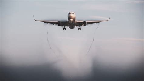 aircraft wing flexing mid-air during turbulence over cloud layer