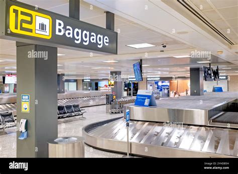 Airline baggage claim area with multiple U.S. carrier logos