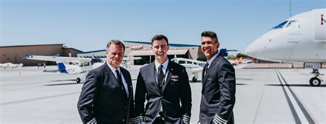 airline captain and first officer walking on runway with aircraft in background