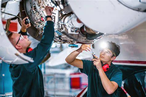 airline maintenance crew servicing Boeing 777 widebody aircraft