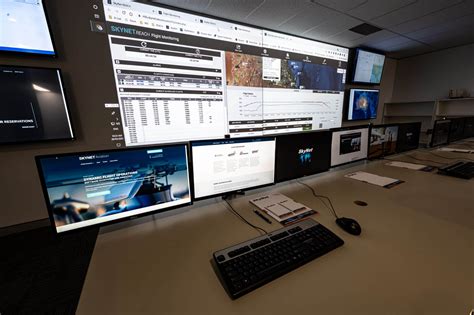 airline operations control center with digital flight tracking systems and staff monitoring screens