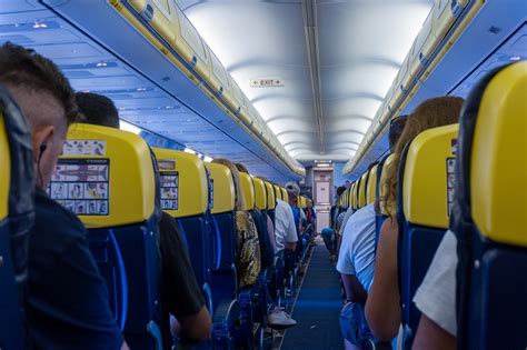 airline passenger discussing downgrade compensation at airport desk