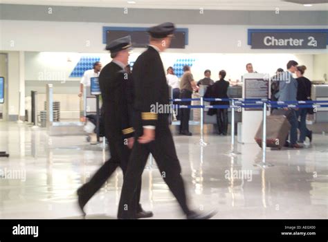 airline pilot walking across airport ramp toward Boeing 737 narrowbody jet