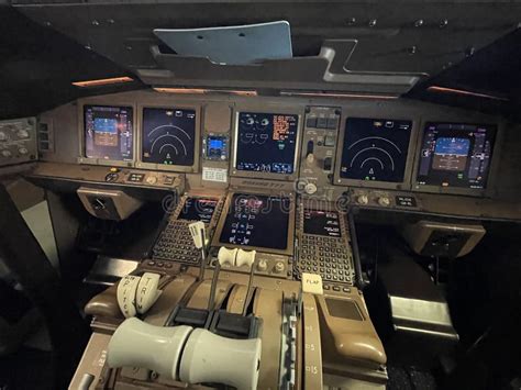airline pilots monitoring Boeing 777 autoland cockpit instruments during low visibility approach