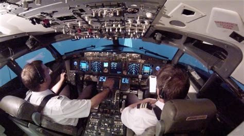 airline pilots performing high speed rejected takeoff in simulator cockpit