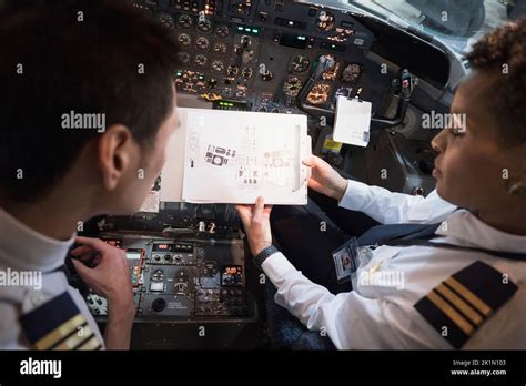 airline pilots reviewing operational data before departure