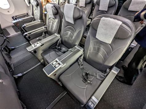 airline premium economy passenger seat with legrest dining service and entertainment screen