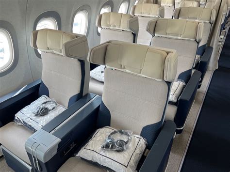 airplane cabin business class European style empty middle seat breakfast service