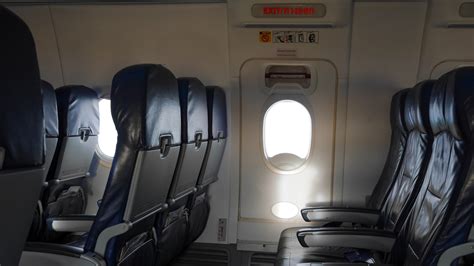 airplane cabin exit row seat safety instructions placard close up