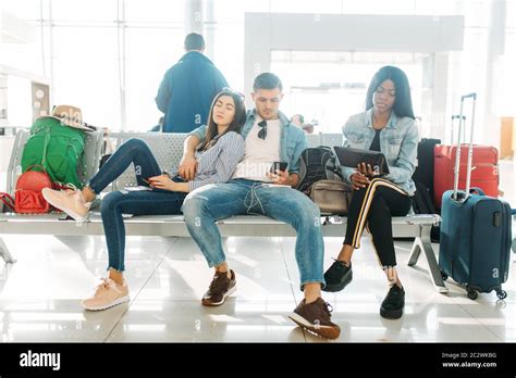 airport baggage area with delayed luggage and passengers waiting