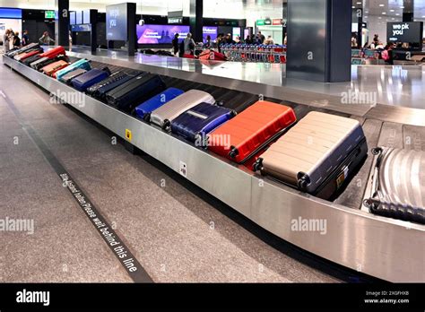 airport baggage carousel with priority tagged business class luggage arriving first