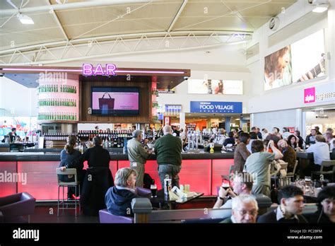 airport bar passengers drinking before flight departure gate lounge