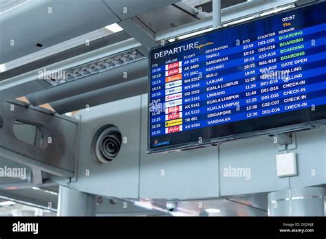 airport departure board with airline crew preparing for international flight