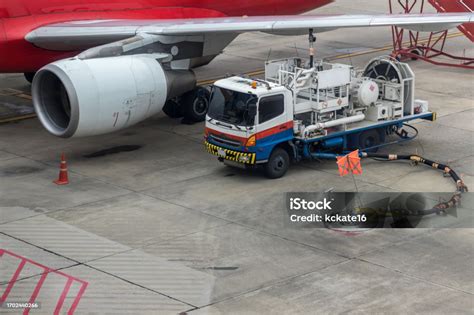 airport fuel truck refueling commercial aircraft close-up