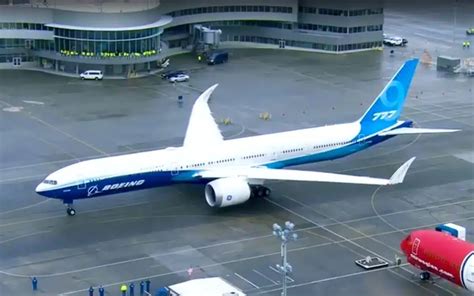 airport ground crew servicing boeing 777x with folded wings