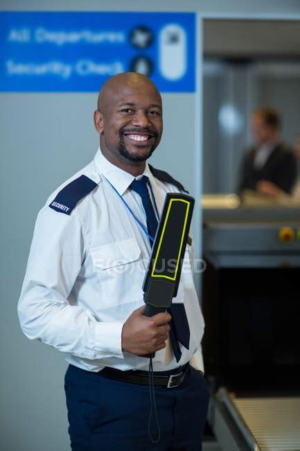airport security officer coordinating with law enforcement after security alert