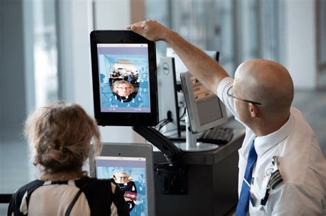 airport security officer using facial recognition scanner