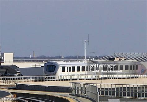 AirTrain JFK moving between airport terminals with cityscape background