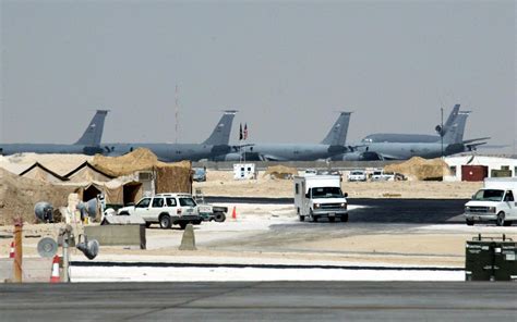 Al Udeid Air Base Qatar US Air Force aircraft parked on massive desert airfield