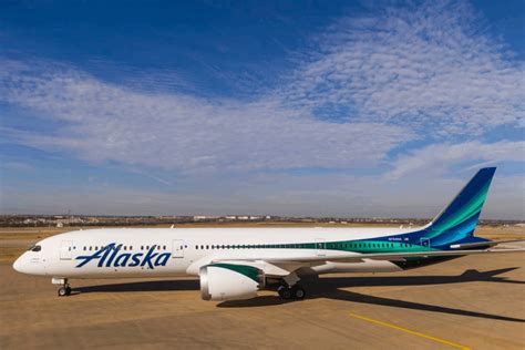 alaska air group boeing 787 on tarmac with tokyo skyline background