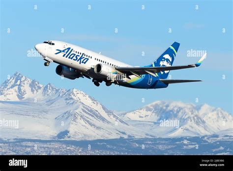 Alaska Airlines Boeing 737 taking off in snowy conditions at Anchorage airport