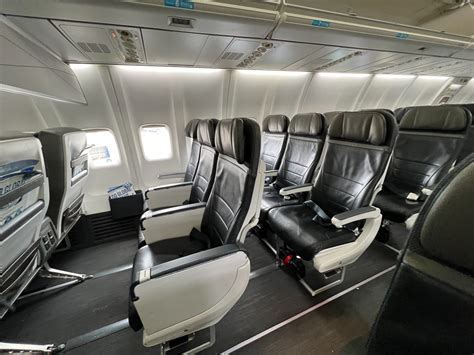 alaska airlines premium class passenger boarding early and stowing luggage overhead