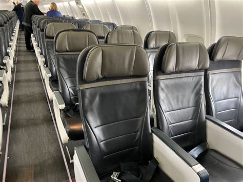alaska airlines premium economy seat row with comfort upgrades and footrest visible