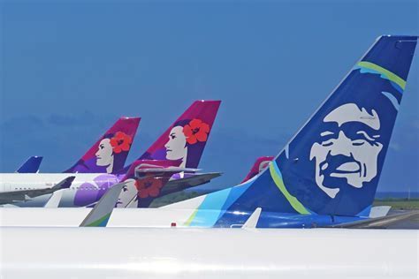 alaska and hawaiian aircraft tail logos overlapping at honolulu airport