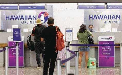 alaska and hawaiian check-in counters with passengers and signage changes