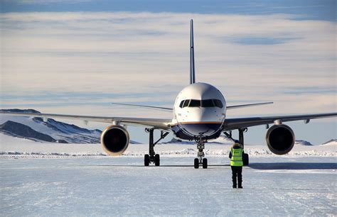 ALE aircraft landing at Union Glacier with mountains in background