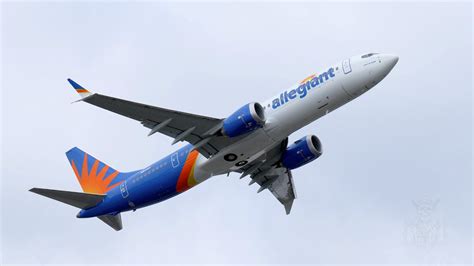 Allegiant Air Boeing 737 aircraft taking off during sunset with orange sky