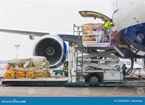allied air crew loading cargo at monrovia airport with branding visible on containers