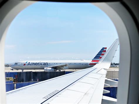 American Airlines aircraft at airport gate with AAdvantage branding