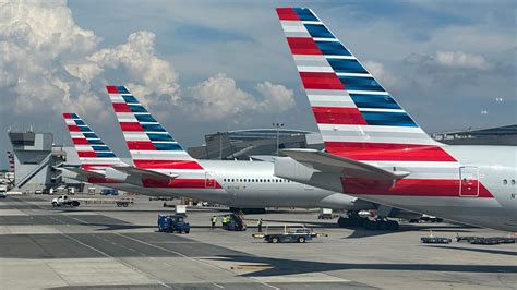 american airlines aircraft at jfk runway with delta planes in background