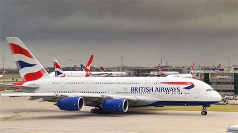 american airlines aircraft taxiing near british airways plane at heathrow