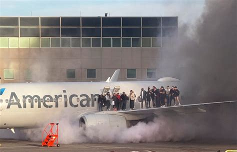 American Airlines aircraft waiting on DFW apron amid heavy rain and lightning