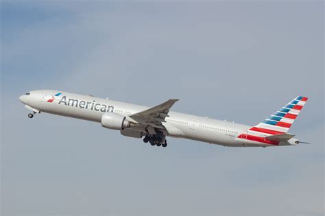 American Airlines Boeing 777 departing JFK Airport at sunset on transatlantic route