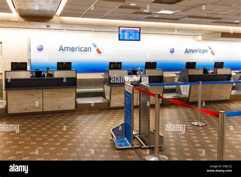 American Airlines check-in counters with passengers at regional airport terminal